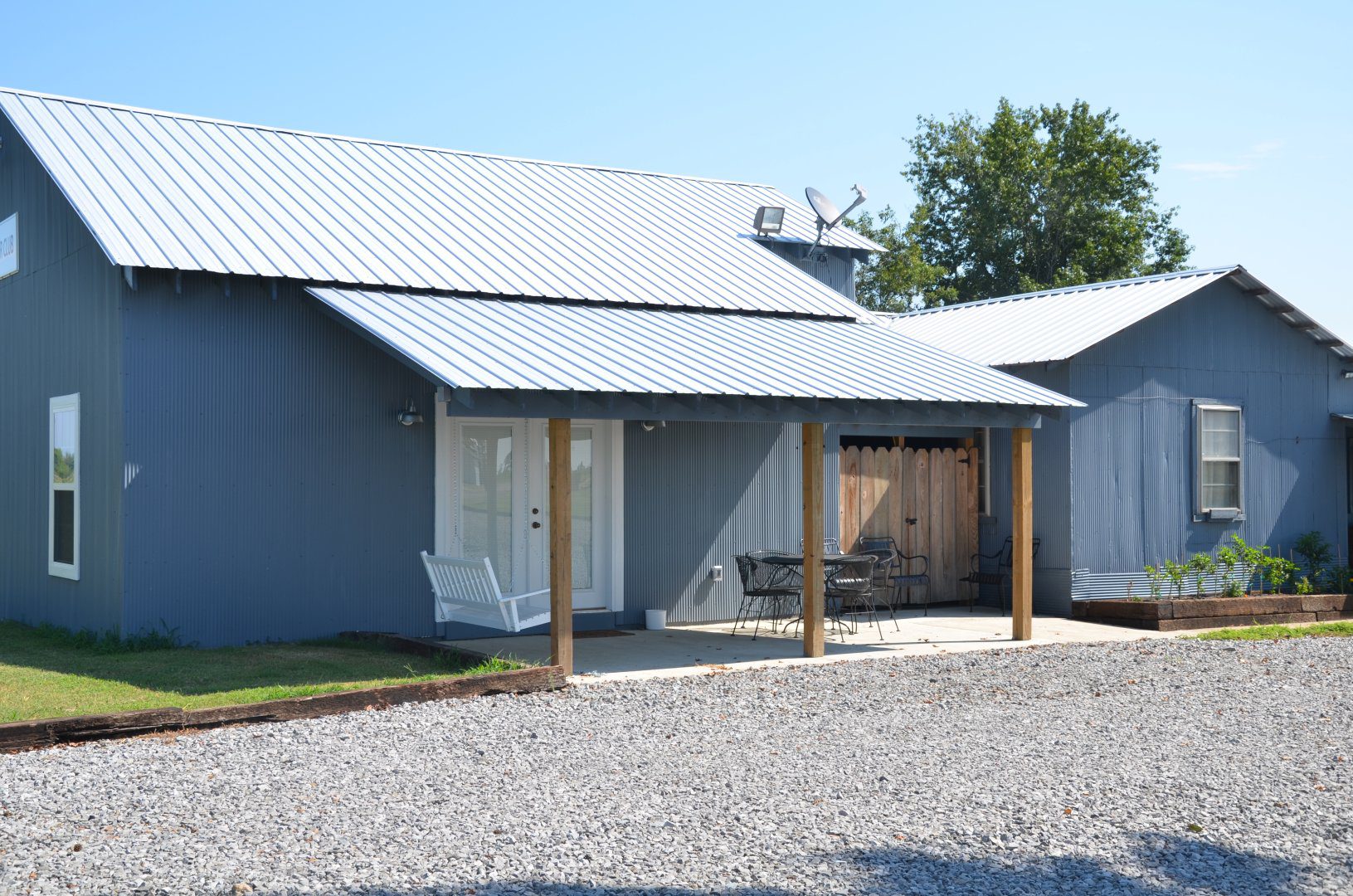 A building with a porch and a wooden roof.