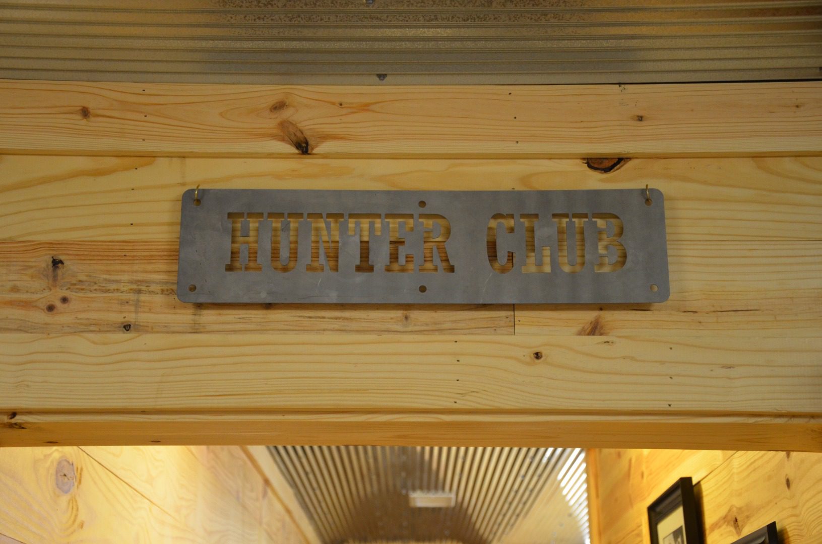 A sign that says hunter club on the side of a building.